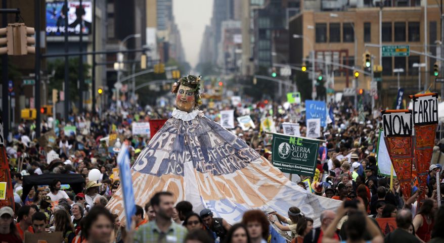 People fill the street during the People&#39;s Climate March, Sunday, Sept. 21, 2014, in New York. Tens of thousands of activists walked through Manhattan on Sunday, warning that climate change is destroying the Earth &amp;#8212; in stride with demonstrators around the world who urged policymakers to take quick action. (AP Photo/Mel Evans)