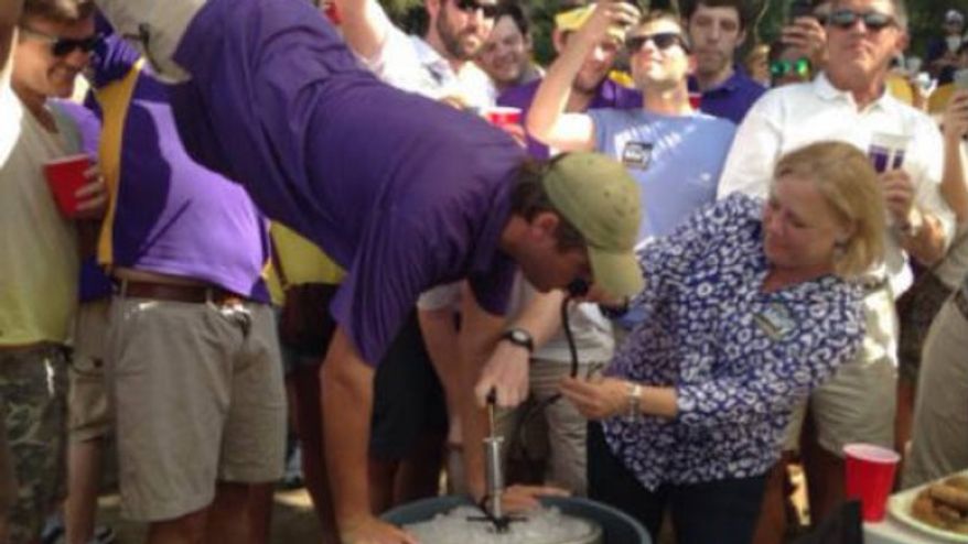 Sen. Mary Landrieu was spotted pouring beer into the mouth of a Louisiana State University fan who was doing a keg stand during a tailgating event on Saturday. (Twitchy)