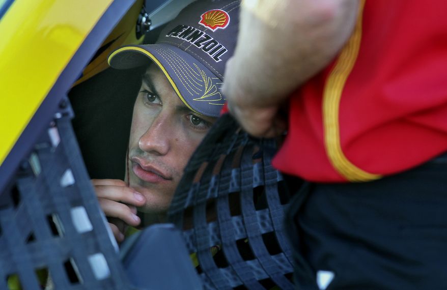 Driver Joey Logano sits in his car before qualifying at NASCAR Sprint Cup auto race at New Hampshire Motor Speedway, in Loudon, N.H., Friday, Sept. 19, 2014 (AP Photo/Cheryl Senter)