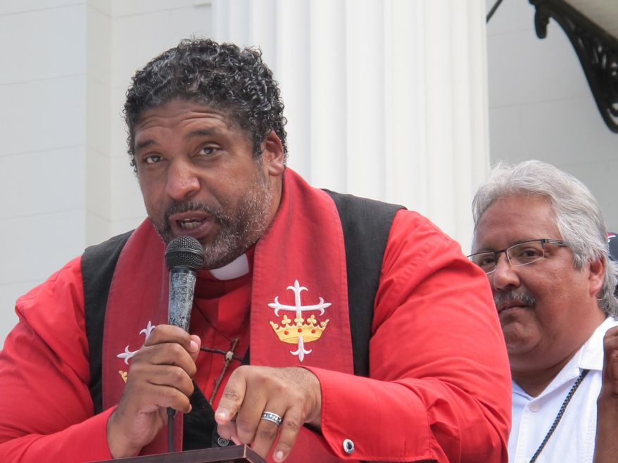 The Rev. William Barber II, founder of the Forward Together Moral Movement in North Carolina, addresses a rally, Monday, Sept. 22, 2014, on the state Capitol steps in Montgomery, Ala. The rally was organized by Alabama groups seeking to start a similar movement in Alabama.(AP Photo/Phillip Rawls)