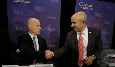 California Gov. Jerry Brown (left) shakes hands with Republican challenger Neel Kashkari before a gubernatorial debate in the state capital of Sacramento. (Associated Press)