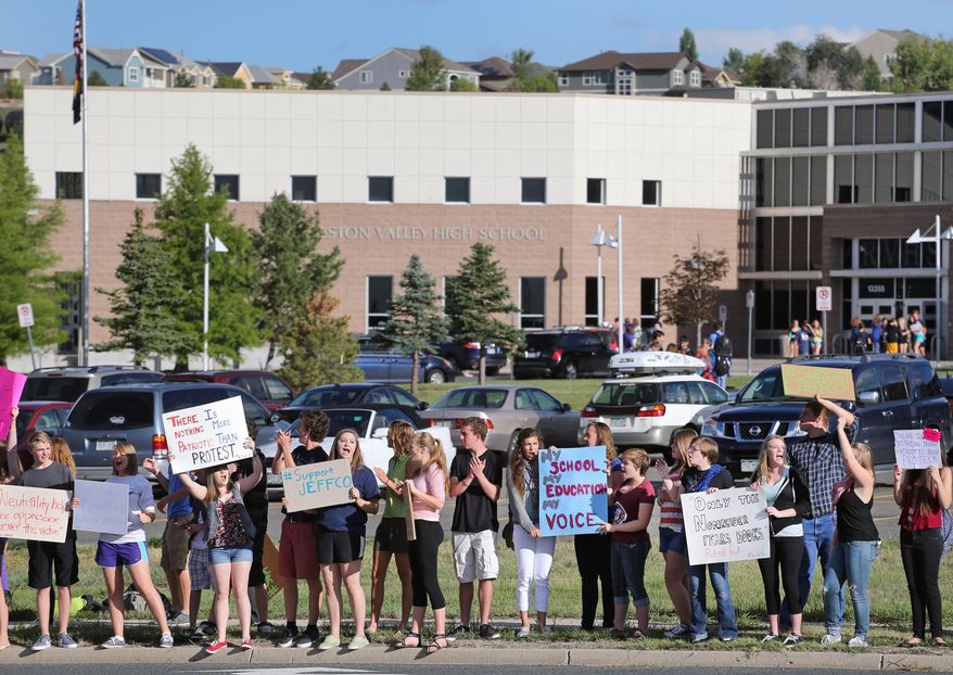 Students protest outside of Ralston Valley High School, Tuesday, Sept. 23, 2014, in Arvada, Colo. The students are protesting a proposal by the Jefferson County School Board to emphasize patriotism and downplay civil unrest in the teaching of U.S. history. (AP Photo/Brennan Linsley)
