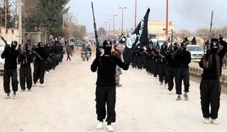 This undated file image posted on a militant website on Tuesday, Jan. 14, 2014, which has been verified and is consistent with other AP reporting, shows fighters from the Islamic State group marching in Raqqa, Syria. (AP Photo/Militant Website, File)