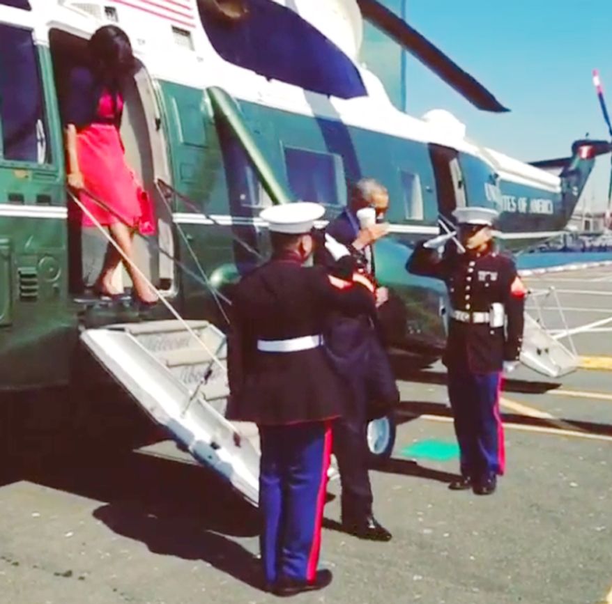 President Obama saluting U.S. Marines while holding a coffee cup. Photo via Instagram