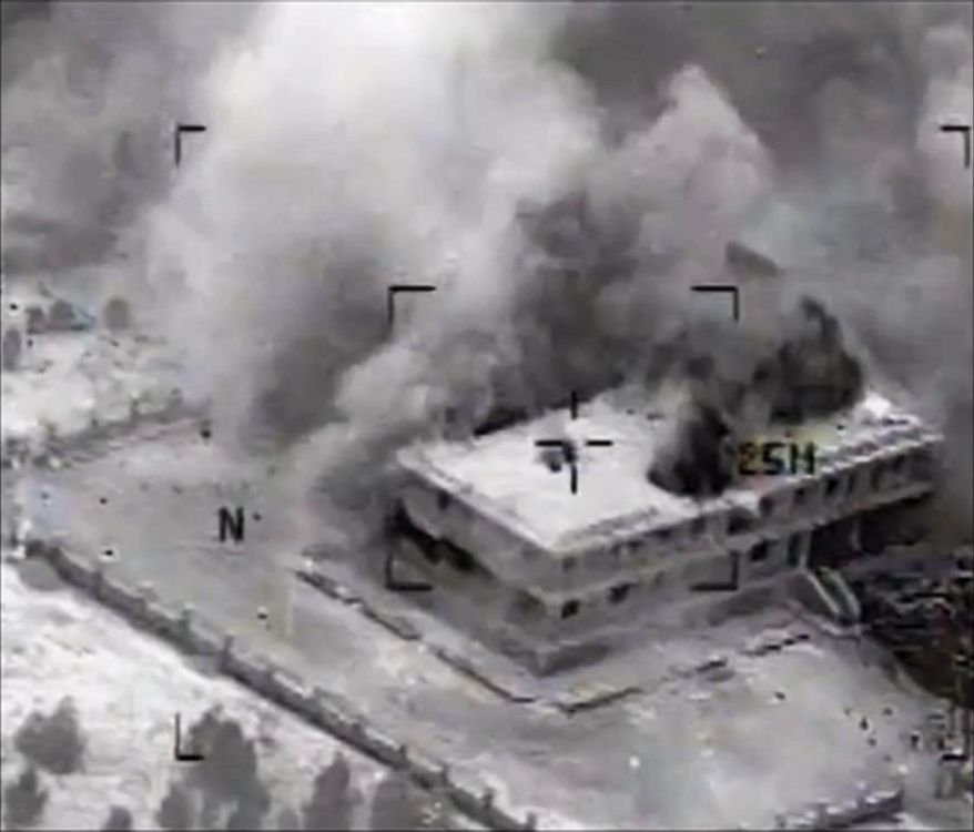 This still image made from video released by the U.S. Central Command on Tuesday, Sept. 23, 2014, shows a structure in Tall Al Qitar, Syria moments after a U.S. airstrike. In three waves of nighttime attacks launched over four hours early on Tuesday, the U.S. and its Arab partners made more than 200 airstrikes against roughly a dozen militant targets in Syria. (AP Photo/US Central Command)