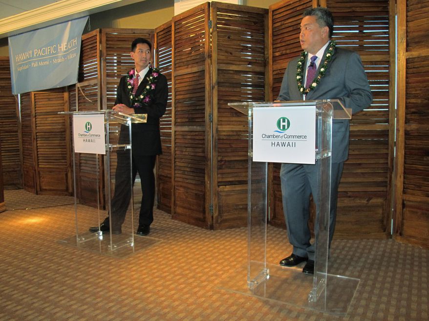 Hawaii U.S. congressional candidates, former U.S. Rep. Charles Djou, left, and state Rep. Mark Takai, participate in a debate hosted by the Chamber of Commerce of Hawaii in Honolulu on Tuesday, Sept. 23, 2014. (AP Photo/Cathy Bussewitz)