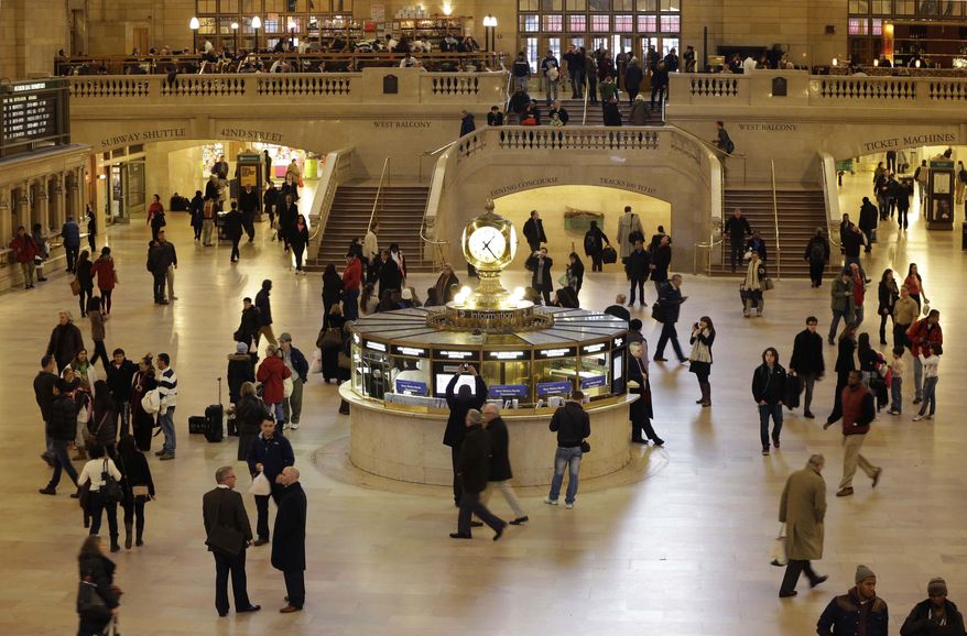 FILE- In this Jan. 9, 2013 file photo, pedestrians and travelers stroll through the main concourse of Grand Central Terminal in New York. The landmark, one of the country's finest examples of Beaux Arts architecture and the most famous train station in America. The New York City licensing test for sightseeing guides has a number of questions about Grand Central. (AP Photo/Kathy Willens, File)