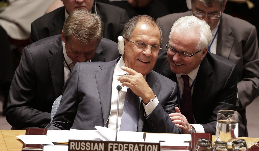 Russian Foreign Minister Sergey Lavrov, left, speaks with Ambassador Vitaly Churkin during a UN Security Council meeting, Wednesday, Sept. 24, 2014, at the United Nations. Members of the Security Council were expected to adopt a resolution that would require all countries to prevent the recruitment and transport of would-be foreign fighters preparing to join terrorist groups such as the Islamic State group. (AP Photo/Julie Jacobson) 