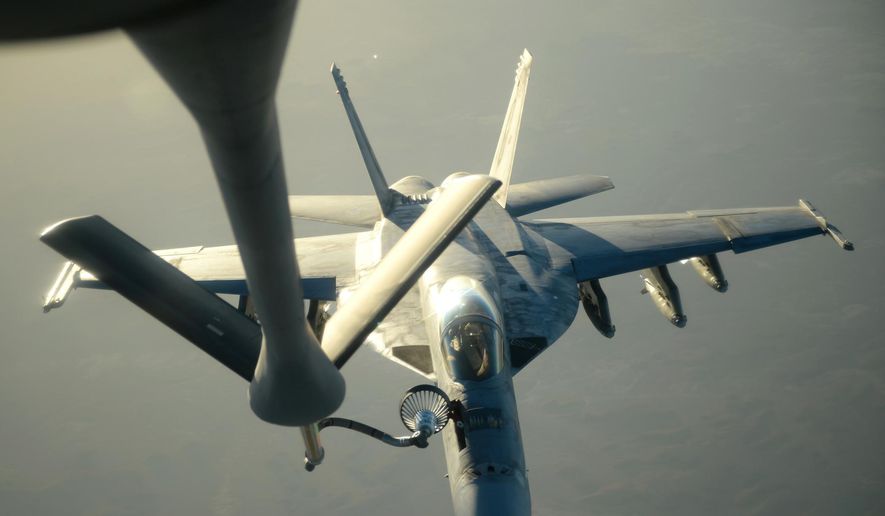 In this Tuesday, Sept. 23, 2014, file photo released by the U.S. Air Force, a U.S. Navy F-18E Super Hornet receives fuel from a KC-135 Stratotanker over northern Iraq after conducting airstrikes as part of U.S. led coalition airstrikes on the Islamic State group and other targets in Syria. (AP Photo/U.S. Air Force, Staff Sgt. Shawn Nickel)