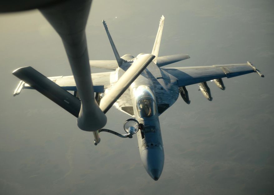In this Tuesday, Sept. 23, 2014, file photo released by the U.S. Air Force, a U.S. Navy F-18E Super Hornet receives fuel from a KC-135 Stratotanker over northern Iraq after conducting airstrikes as part of U.S. led coalition airstrikes on the Islamic State group and other targets in Syria. (AP Photo/U.S. Air Force, Staff Sgt. Shawn Nickel)