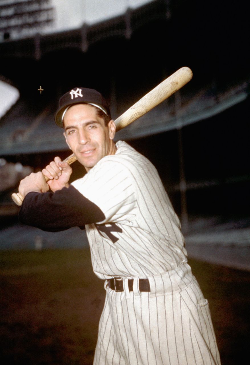 Yankees infielder Phil Rizzuto with bat in hand poses March 1950. (AP Photo)