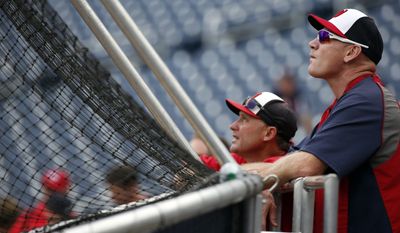 Washington Nationals bench coach Randy Knorr, left, and manager Matt Williams watch batting practice before a baseball game against the Philadelphia Phillies at Nationals Park Thursday, July 31, 2014, in Washington. (AP Photo/Alex Brandon)
