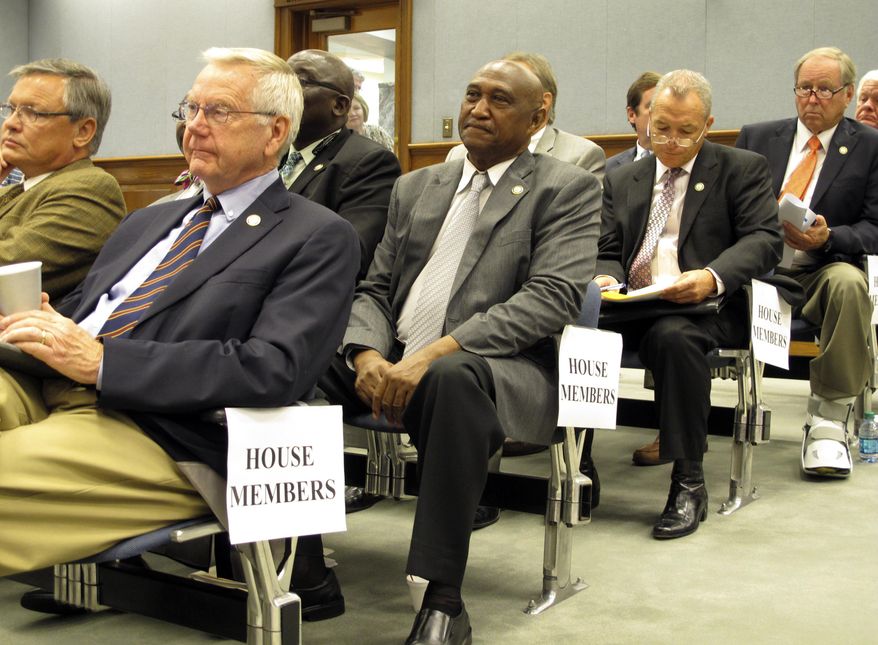 Lawmakers listen to a presentation from Gov. Bobby Jindal's administration about its planned changes to the state employee health insurance program Thursday, Sept. 25, 2014, in Baton Rouge, La. The insurance changes have generated fierce complaints that they are tied to Jindal's mismanagement of the program. (AP Photo/Melinda Deslatte)