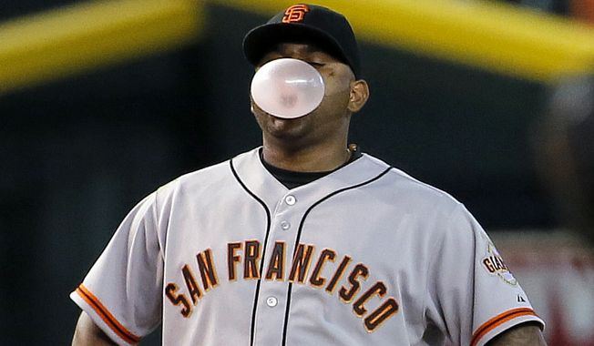 San Francisco Giants&#x27; Pablo Sandoval blows a gum bubble between pitches against the Arizona Diamondbacks during the seventh inning of a baseball game, Wednesday, Sept. 17, 2014, in Phoenix. (AP Photo/Matt York) 