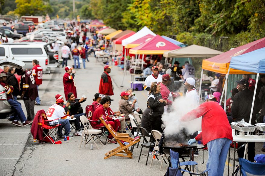 Football fans tailgate in the parking lot before the Washington Redskins play the New York Giants in NFL football at FedExField, Landover, Md., Thursday, September 25, 2014. (Andrew Harnik/The Washington Times)
