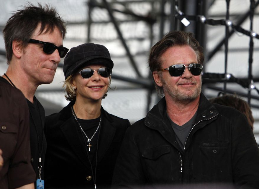FILE - In this Sept. 22, 2012 file photo, performer John Mellencamp, right, and actress Meg Ryan, center, watch Dale Watson perform at the start of Farm Aid 2012 concert at Hersheypark Stadium in Hershey, Pa. (AP Photo/Jacqueline Larma, File)
