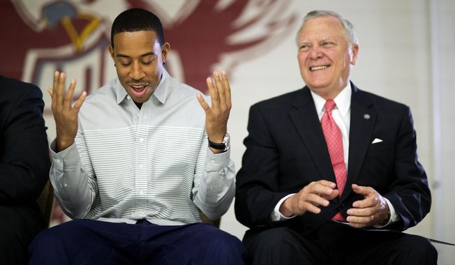 Rapper Ludacris, left, bows his head as he&#x27;s introduced during a visit to the charter school Utopian Academy for the Arts with Georgia Gov. Nathan Deal, right, Friday, Sept. 26, 2014, in Riverdale, Ga. Deal and Ludacris may seem like an odd pairing for a campaign event, but the duo was a hit with a cheering crowd of students Friday. Christopher &amp;quot;Ludacris&amp;quot; Bridges has been an outspoken supporter of President Barack Obama, penning a profane song during the 2008 campaign criticizing his opponents. But Deal says he couldn&#x27;t think of anyone better to inspire students at the event. (AP Photo/David Goldman) **FILE**