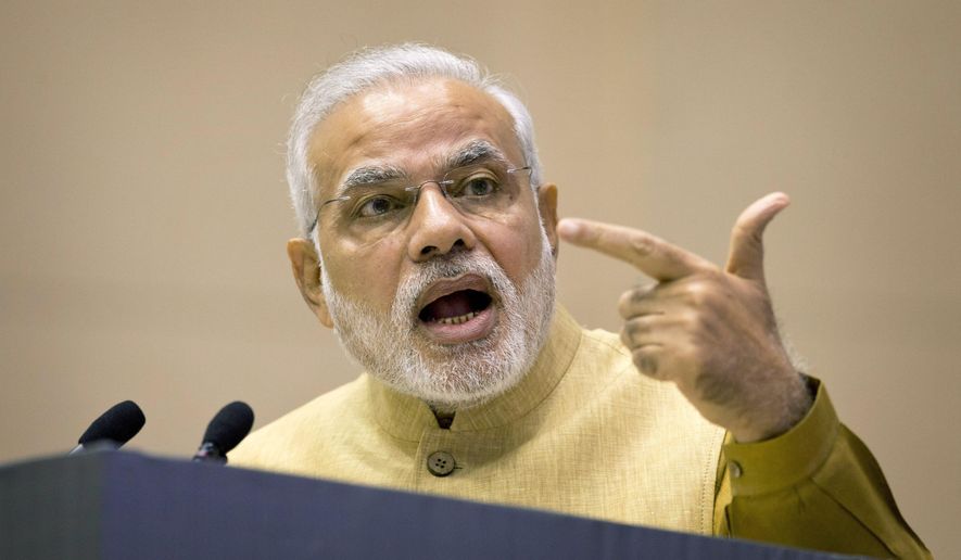 FILE - In this Thursday, Sept. 25, 2014, file photo, Indian Prime Minister Narendra Modi addresses business leaders as he launches his "Make in India" initiative, in New Delhi, prior to his scheduled departure to the United States. A human rights group has sued Modi in New York for what it says was his complicity in sectarian violence in his country in 2002. (AP Photo/Saurabh Das, File)
