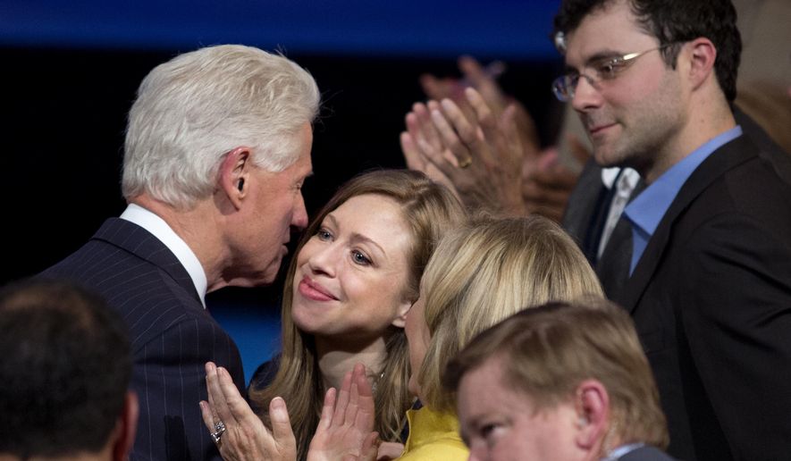 Former President Bill Clinton hugs his daughter, Chelsea Clinton, during the closing session of the Clinton Global Initiative in New York Wednesday, Sept. 24, 2014. At right is Chelsea&#39;s husband, Marc Mezvinsky. (AP Photo/Craig Ruttle)