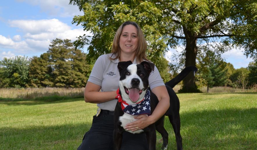 ADVANCE FOR MONDAY SEPT 29 AND THEREAFTER-This Thursday Sept 18, 2014 photo shows Jefferson County Animal Control officer Elaina Maze with Chip, the “poster dog” for Pets for Patriots in Leetown, W.Va. Maze helped start the Pets for Patriots program in Jefferson County and hopes to connect veterans with a best friend.  (AP Photo/The Journal, Mary Stortstrom)