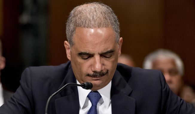 This June 6, 2013, file photo shows U.S. Attorney General Eric Holder testifying on Capitol Hill in Washington before a Senate Appropriations subcommittee. (AP Photo/J. Scott Applewhite, File)