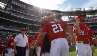 Washington Nationals left fielder Steven Souza (21) celebrates with his teammates after a baseball game against the Miami Marlins at Nationals Park, Sunday, Sept. 28, 2014, in Washington. Souza made a diving catch to end the game. Jordan Zimmermann pitched a no-hitter, and the Nationals won 1-0. (AP Photo/Alex Brandon)