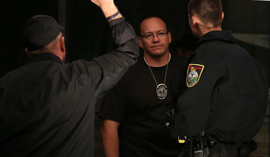 Springville police officers stand outside a house where a family of five, a father, 36, a mother, 37, and children ages 14,12,11, was found dead in Springville, Utah, on Saturday, Sept. 27, 2014. (AP Photo/The Deseret News, Laura Seitz)