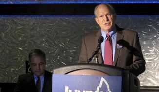 Independent gubernatorial candidate Bill Walker speaks during a debate with Republican Gov. Sean Parnell, seated at left, on Monday, Sept. 29, 2014, in Juneau, Alaska. Walker and Parnell clashed on state spending and a gas line project. (AP Photo/Becky Bohrer)