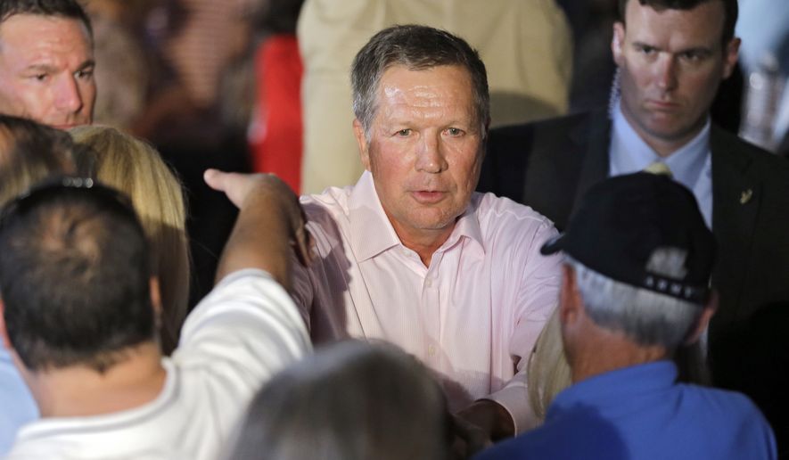 Ohio Gov. John Kasich greets supporters after a GOP Get Out the Vote rally in Independence, Ohio, Monday, Sept. 29, 2014. (AP Photo/Mark Duncan)