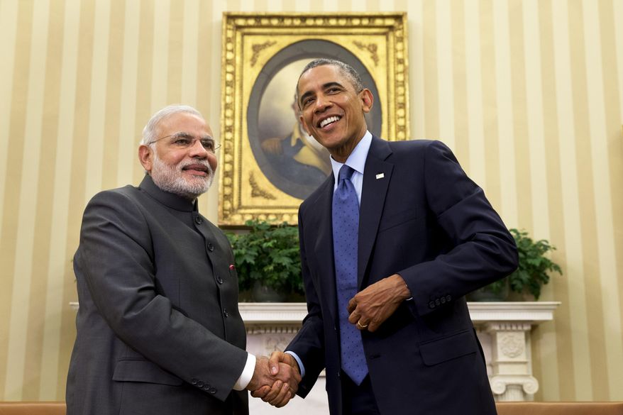 President Barack Obama shakes hands with Indian Prime Minister Narendra Modi, Tuesday, Sept. 30, 2014, in the Oval Office of the White House in Washington. President Barack Obama and India's new Prime Minister Narendra Modi said Tuesday that "it is time to set a new agenda" between their countries, addressing concerns that the world's two largest democracies have grown apart. (AP Photo/Evan Vucci)