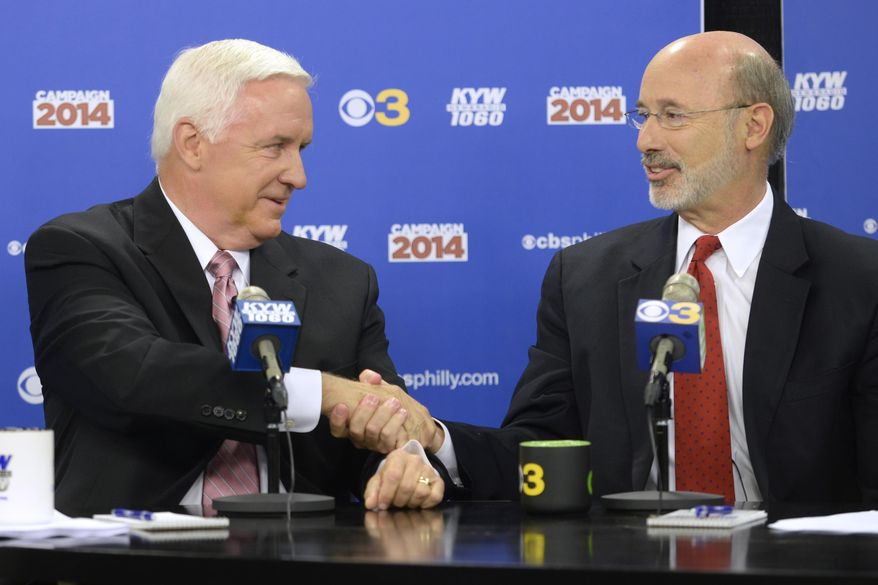 Republican Gov. Tom Corbett, left, and Democratic challenger Tom Wolf shake hands following their debate at "Breakfast with the Candidates" event at KYW-TV and KYW-AM on Wednesday, Oct. 1, 2014 in Philadelphia. The second debate between the two became tense as Wolf sought to assign blame to Corbett for budget deficits and struggling schools while Corbett tried to frame Wolf as the candidate who will favor labor unions over taxpayers. (AP Photo/The Philadelphia Inquirer, Tom Gralish, Pool)