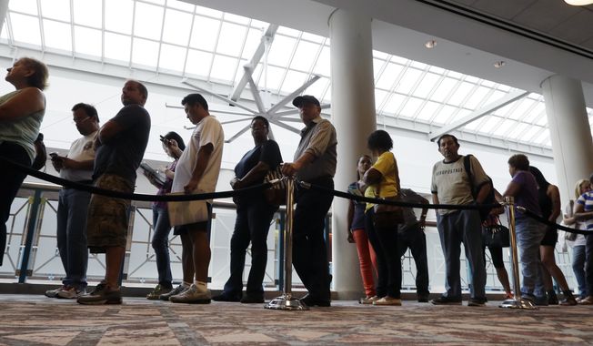 In this Sept. 3, 2014, file photo, people wait in line to sign up for unemployment in Atlantic City, N.J. (AP Photo/Mel Evans, File)