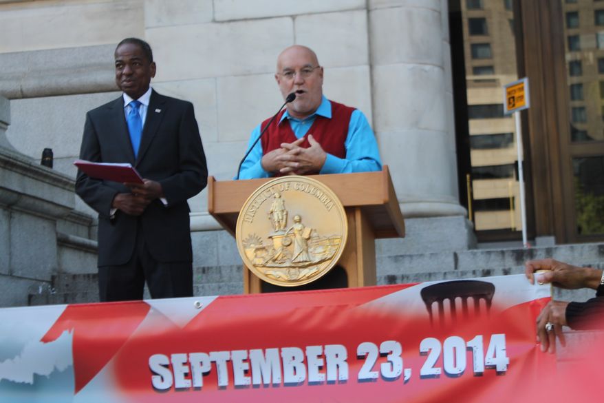 Jose Sueiro, with the D.C. Hispanic Contractors Association, speaks at the "Where's the $1 Billion" rally as D.C. Council member Vincent Orange looks on. Supporters say the D.C. government is giving short-shrift on contracts to small businesses. (Photo by Malcolm Barnes)