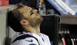 New England Patriots quarterback Tom Brady sits on the bench during the fourth quarter of an NFL football game against the Kansas City Chiefs, Monday, Sept. 29, 2014, in Kansas City, Mo. The Chiefs won 41-14. (AP Photo/Charlie Riedel)