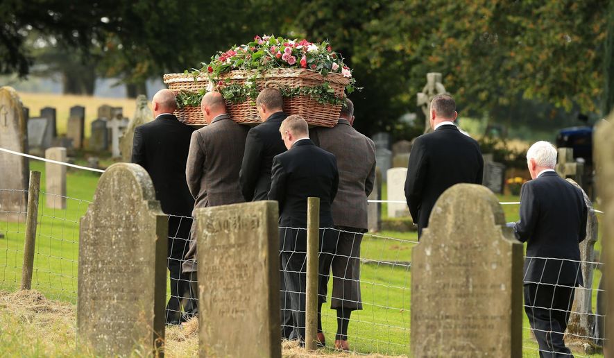 The coffin of Deborah, the Dowager Duchess of Devonshire is carried from St Peter's Church following her funeral service, on the Chatsworth estate, England, Thursday Oct. 2, 2014. The last of the famous Mitford sisters, the Dowager Duchess of Devonshire, died at the age of 94. (AP Photo/PA, Lynne Cameron) UNITED KINGDOM OUT NO SALES NO ARCHIVE