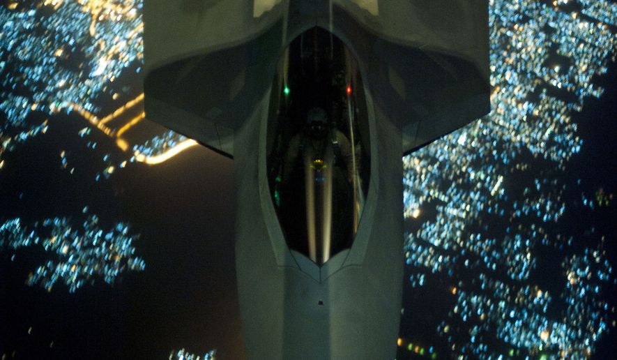AP10ThingsToSee - In this Friday, Sept. 26, 2014 photo, released by the U.S. Air Force, a U.S Air Force KC-10 Extender refuels an F-22 Raptor fighter aircraft prior to strike operations in Syria. The F-22s, making their combat debut, were part of a strike package that was engaging Islamic State group targets in Syria. Washington and its Arab allies opened the air assault against the extremist group on Sept. 23, striking military facilities, training camps, heavy weapons and oil installations. The campaign expands upon the airstrikes the United States has been conducting against the militants in Iraq since early August. (AP Photo/U.S. Air Force, Russ Scalf )
