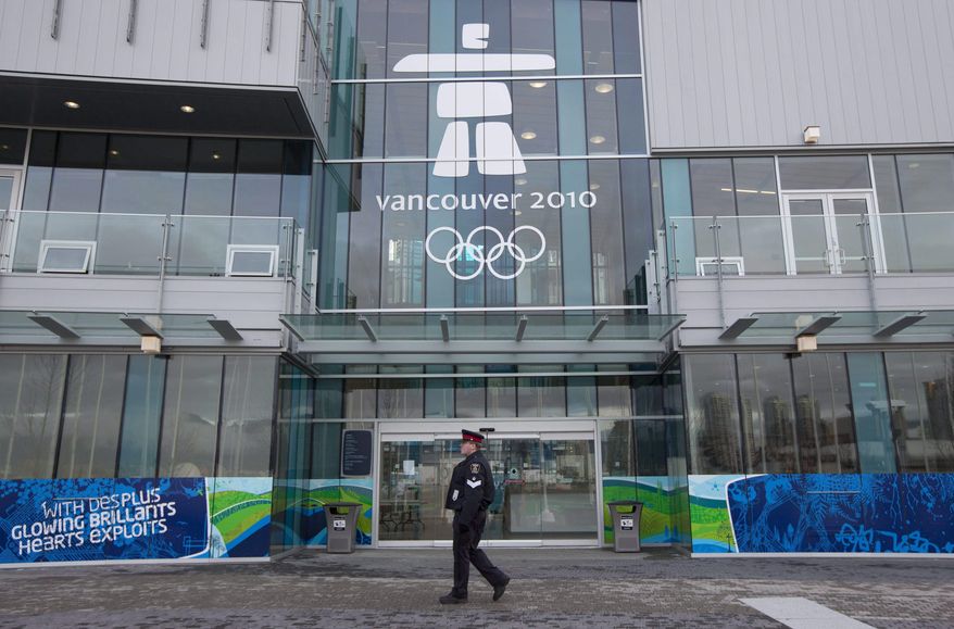FILE In this Feb. 2, 2010 file photo, a  police officer is seen walking past the athletes village entrance in downtown Vancouver, British Columbia, Canada.  Why are so many cities saying no to the Winter Olympics? It’s all about the money. The official organizing budget for the Vancouver 2010 Olympic was an estimated $2 billion. Total costs were put at around $6 billion, including expansion of the Sea to Sky Highway between Vancouver and Whistler. Vancouver&#39;s biggest problem centered on a project to turn the athletes village into a downtown waterfront neighborhood. (AP Photo/The Canadian Press,Jonathan Hayward, File) **FILE**