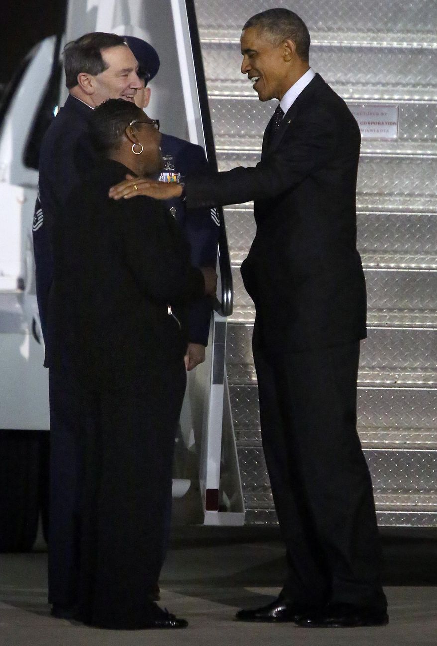 President Barack Obama, right, talks with Gary, Ind. Mayor Karen Freeman-Wilson, left, while U.S. Senator Joe Donnely looks after arriving at the Gary/Chicago International Airport in Gary, Ind., Wednesday, Oct. 1, 2014. (AP Photo/The Times, John J. Watkins) MANDATORY CREDIT; CHICAGO LOCALS OUT; GARY OUT