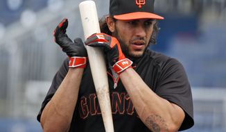 San Francisco Giants&#39; Michael Morse listens as he taps his bat during an MLB baseball workout at Nationals Park, Thursday, Oct. 2, 2014, in Washington. The Washington Nationals play the San Francisco Giants in the National League Division Series starting Friday. (AP Photo/Alex Brandon)
