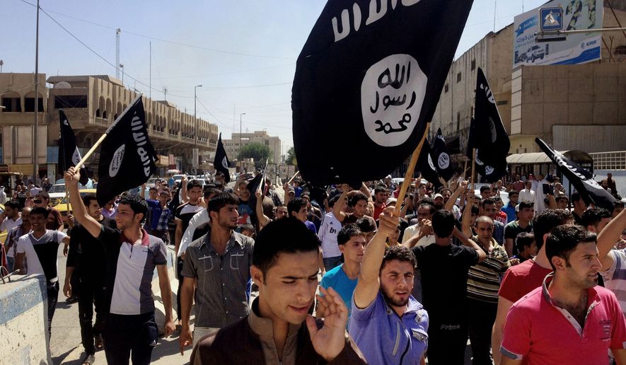 In this June 16, 2014, file photo, demonstrators chant pro-Islamic State group slogans as they carry the group&#39;s flags in front of the provincial government headquarters in Mosul, 225 miles (360 kilometers) northwest of Baghdad. (AP Photo, File) **FILE**