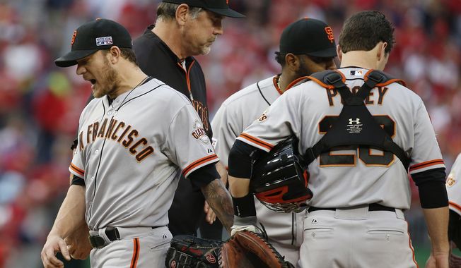 San Francisco Giants starting pitcher Jake Peavy, left, reacts as he leaves the mound during the sixth inning of Game 1 of baseball&#x27;s NL Division Series against the Washington Nationals at Nationals Park, Friday, Oct. 3, 2014, in Washington. (AP Photo/Alex Brandon)