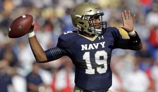 Navy quarterback Keenan Reynolds throws to a receiver in the first half of an NCAA college football game against Rutgers in Annapolis, Md., Saturday, Sept. 20, 2014. (AP Photo/Patrick Semansky)