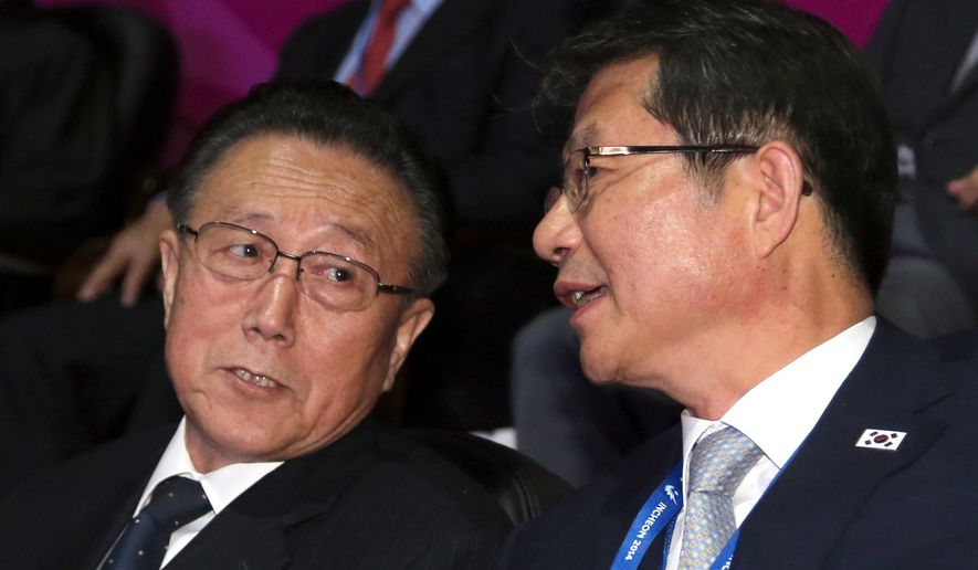 Kim Yang Gon, left, North Korea’s ruling Workers Party secretary, talks with South Korean Unification Minister Ryoo Kihl-jae during the closing ceremony for the 17th Asian Games in Incheon, South Korea, Saturday, Oct. 4, 2014. Hwang, North Korea&#39;s presumptive No. 2, and other members of Pyongyang&#39;s inner circle met with South Korean officials Saturday in the rivals&#39; highest level face-to-face talks in five years, a possible indication that both sides are interested in pursuing better ties after months of animosity. (AP Photo/Yonhap, Bae Jae-man) KOREA OUT