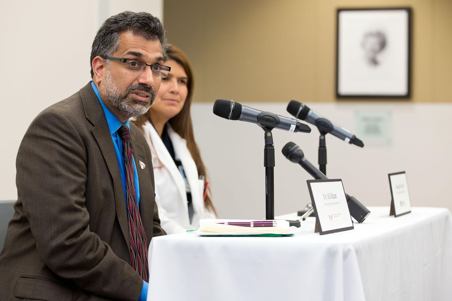 Dr. Ali Khan, left, Dean of the College of Public Health at the Nebraska Medical Center speaks during a news conference in Omaha, Neb., Friday, Oct. 3, 2014, to discuss Ebola patient, journalist Ashoka Mukpo, who is expected to arrive from Liberia at the Medical Center on Monday. Rosanna Morris, Chief Nursing officer, listens at right. (AP Photo/The Omaha World-Herald/Ryan Soderlin) MAGS OUT, TV OUT