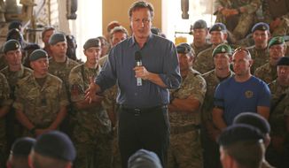 Britain&#x27;s Prime Minister David Cameron, centre, addresses British troops, in Camp Bastion, Afghanistan, Friday, Oct. 3, 2014. Cameron on Friday pledged support for Afghanistan&#x27;s newly sworn-in president and the country&#x27;s new unity government, saying during a surprise visit to Kabul that Britain is committed to helping Afghans build a more secure and prosperous future. (AP Photo/Dan Kitwood, Pool)