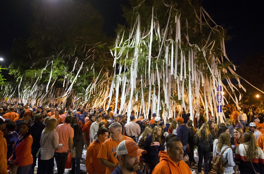 Auburn fans roll Toomer's Corner after Auburn defeated LSU 41-7 in an NCAA college football game Saturday, Oct. 4, 2014, in Auburn, Ala. (AP Photo/Butch Dill)