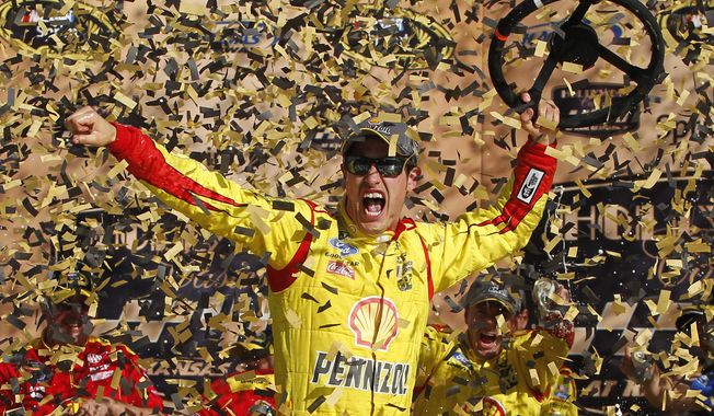 NASCAR Sprint Cup Series driver Joey Logano celebrates his victory in the Hollywood Casino 400 at Kansas Speedway in Kansas City, Kan., Sunday, Oct. 5, 2014. (AP Photo/Colin E. Braley)