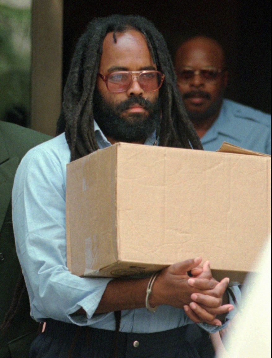 In this July 12, 1995, file photo, convicted police killer and death-row activist Mumia Abu-Jamal leaves Philadelphia&#39;s City Hall after a hearing. Mumia Abu-Jamal, a one-time death row inmate now serving a life sentence for the 1981 murder of a Philadelphia police officer spoke to students graduating from a Vermont college on Sunday, Oct. 5, 2014, encouraging them to strive to transform the world.(AP Photo/Chris Gardner, File)