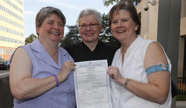 Sharon Baldwin, left, and Mary Bishop, right, pose for photos with their marriage certificate, and Oklahoma Court of Civil Appeals Judge Jane Wiseman, who officiated their wedding ceremony on the courthouse steps, in Tulsa, Okla., Monday, Oct. 6, 2014. Ms. Bishop and Ms. Baldwin were the lead plaintiffs who challenged Oklahoma&#x27;s ban on same-sex marriage in 2004, shortly after 76 percent of Oklahoma voters approved the ban. The wedding came after the U.S. Supreme Court earlier Monday declined to take up the state&#x27;s appeal in the case, and a federal appeals court lifted its stay. (AP Photo/Sue Ogrocki)