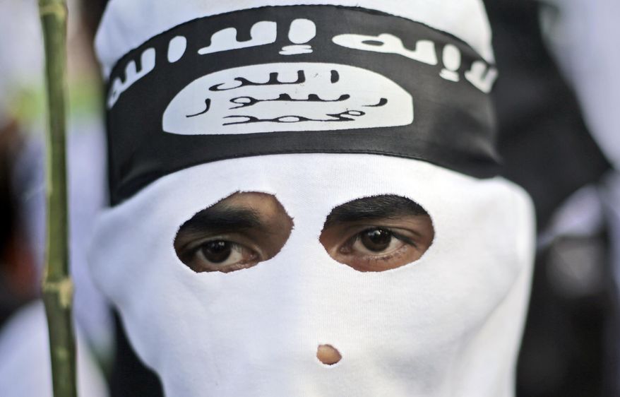 A Muslim man wears a headband showing the Islamic State group's symbol. A lax legislative approach in some European countries makes it hard to prosecute returning militants. (Associated Press/File)